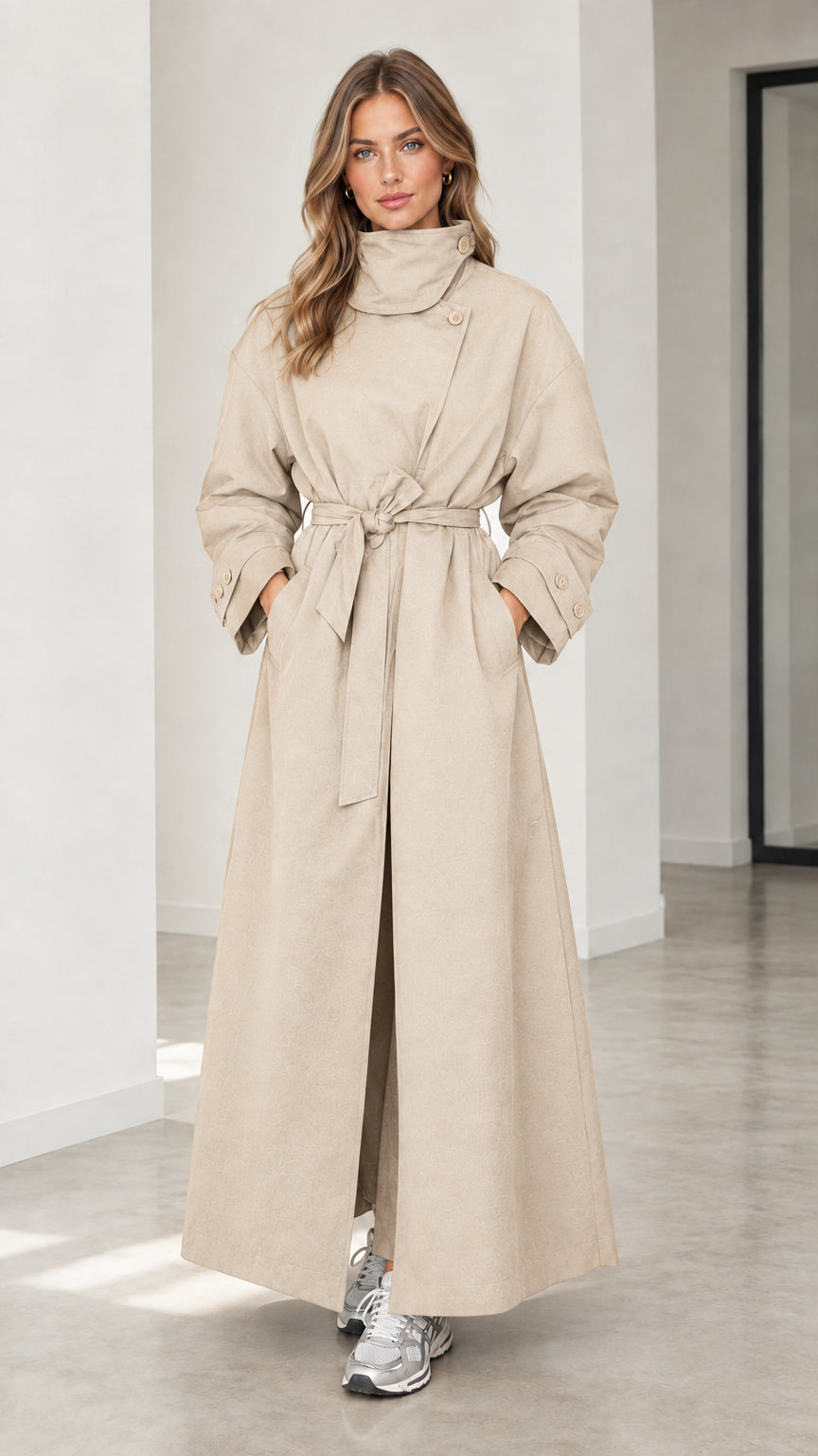 Front full view of woman wearing light beige high neck maxi belted trench coat