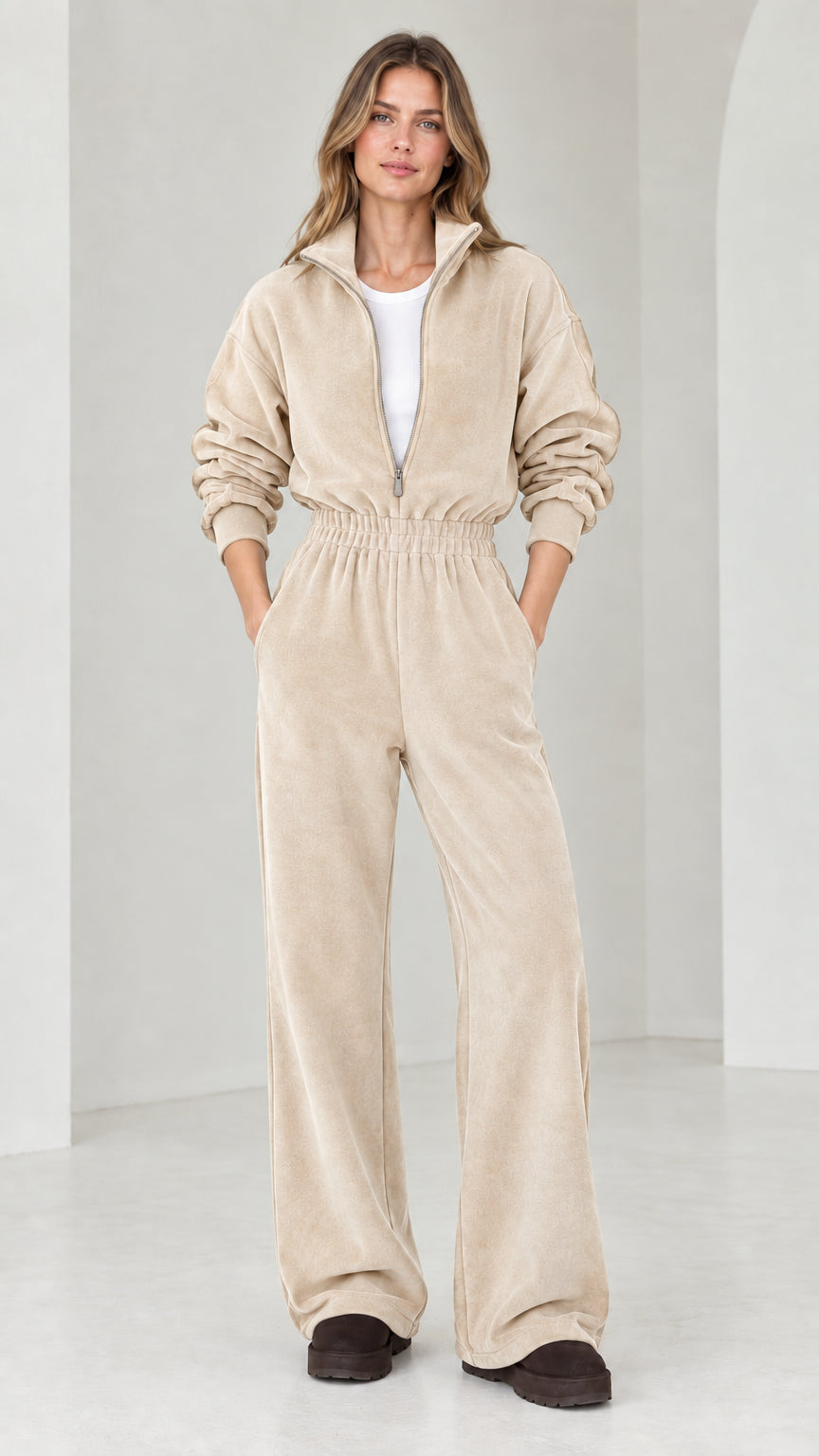 Front view of model wearing beige oatmeal half-zip wide leg fleece jumpsuit