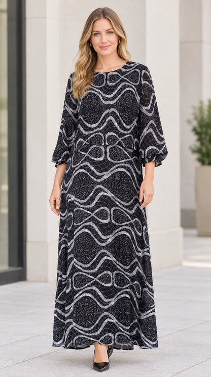 Front view of model wearing black abstract wave print maxi dress with long sleeves