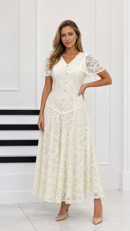 Full-length front view of cream floral lace maxi dress with capelet sleeves and button front