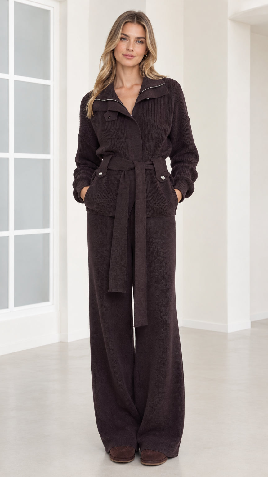 Front view of woman wearing dark brown ribbed knit belted jacket and wide-leg pants set