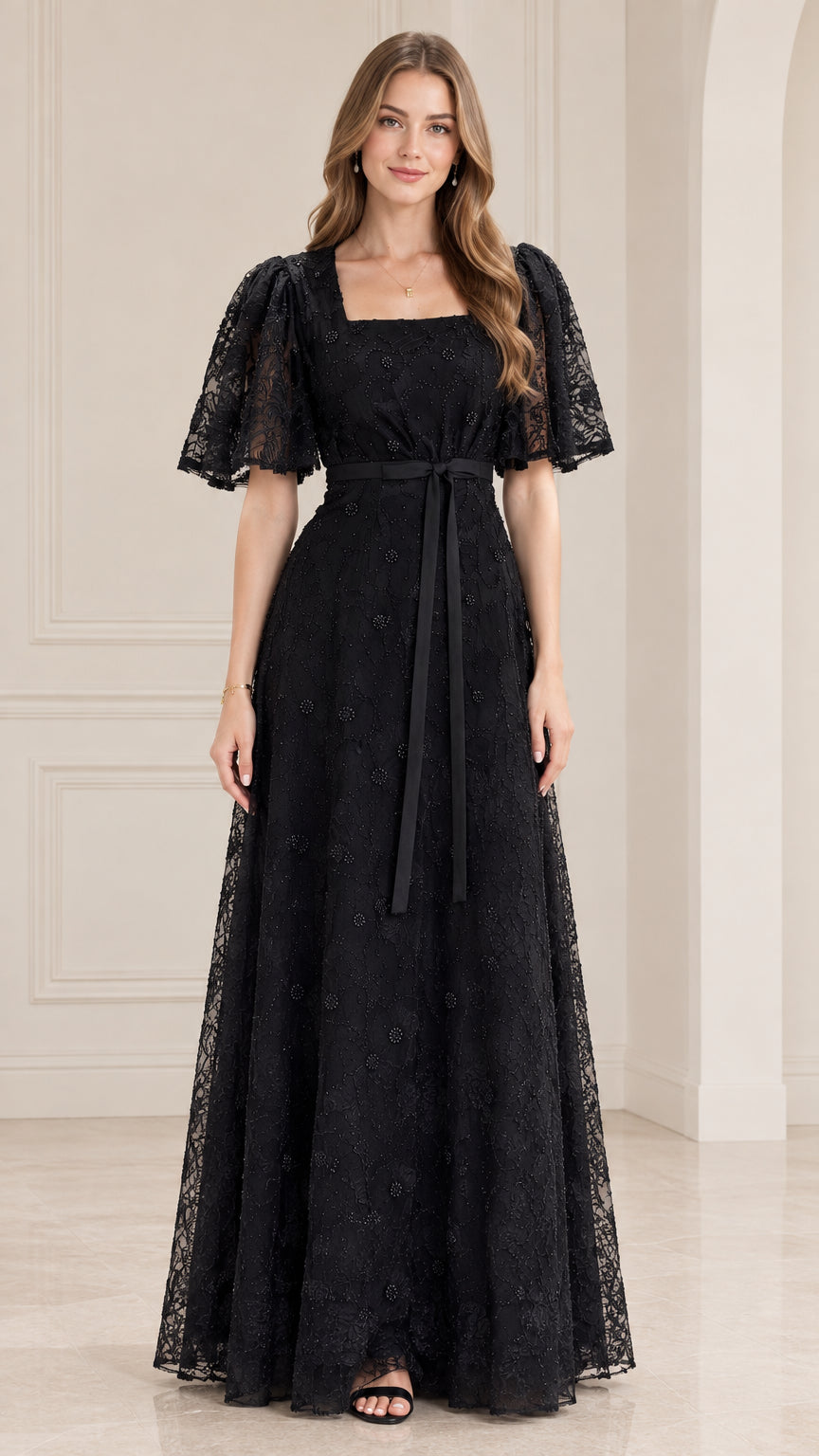 Front view of model wearing black square neck lace maxi dress with flutter sleeves