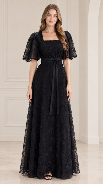 Front view of model wearing black square neck lace maxi dress with flutter sleeves