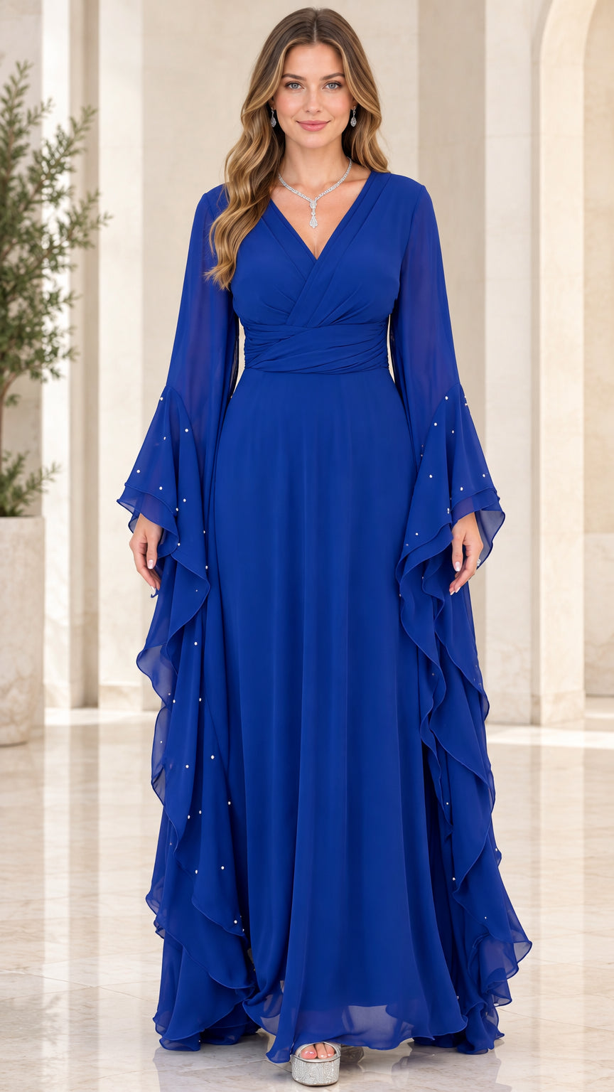 Front view of woman wearing Royal Blue V-neck chiffon maxi dress with pearl-accented bell sleeves