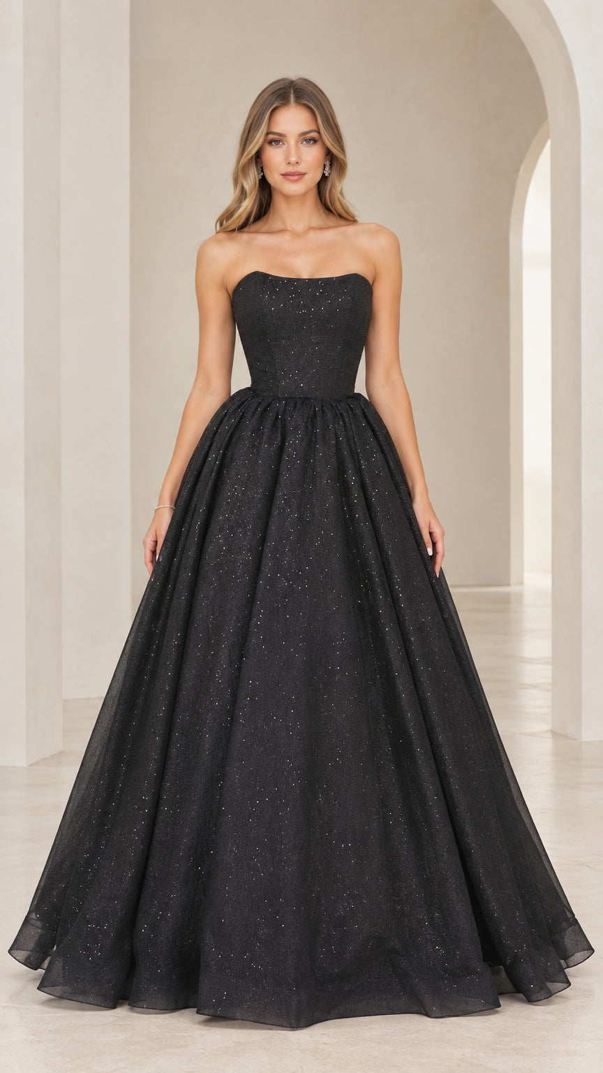 Front view of model wearing black strapless glitter A-line ball gown