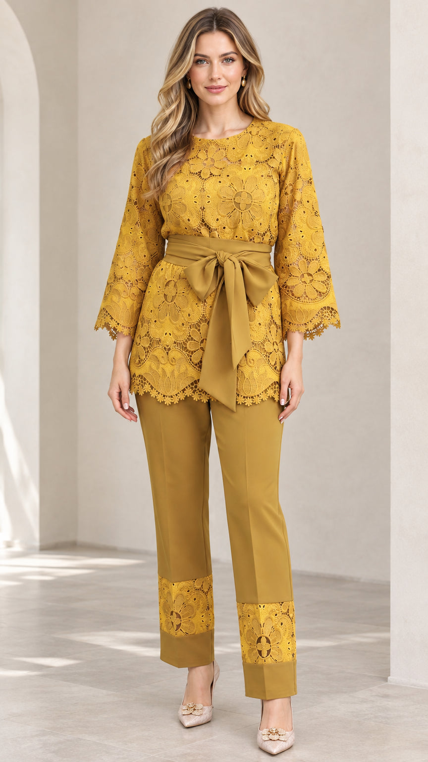 Front full-length view of woman wearing mustard yellow lace tunic top and matching trousers with tie belt
