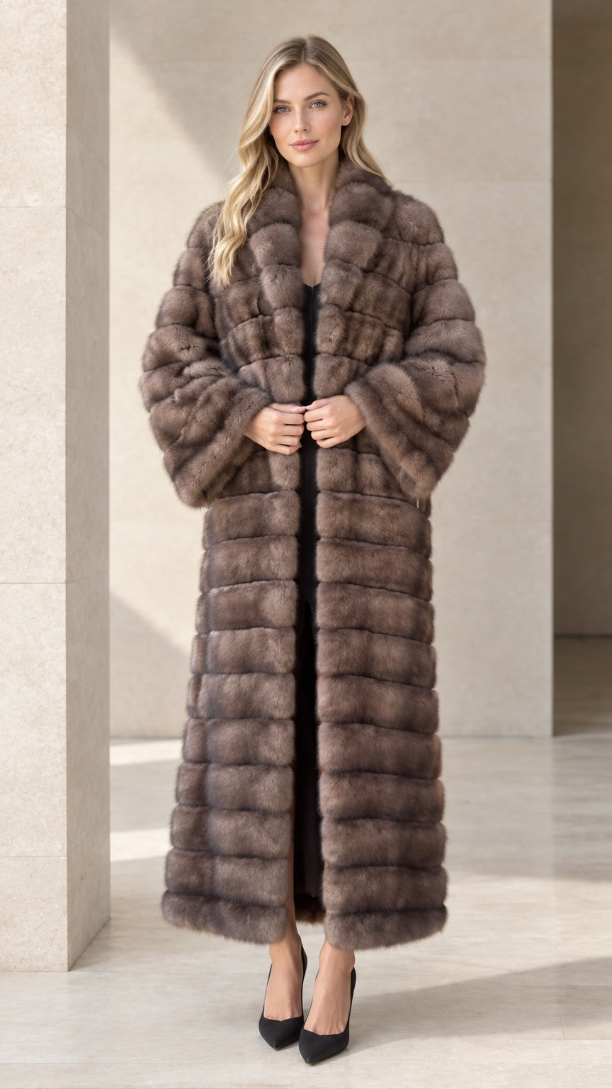 Full front view of model wearing a taupe horizontal paneled faux fur maxi coat with black pumps