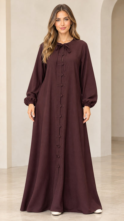 Burgundy long sleeve maxi dress with tie neck and frog buttons front view