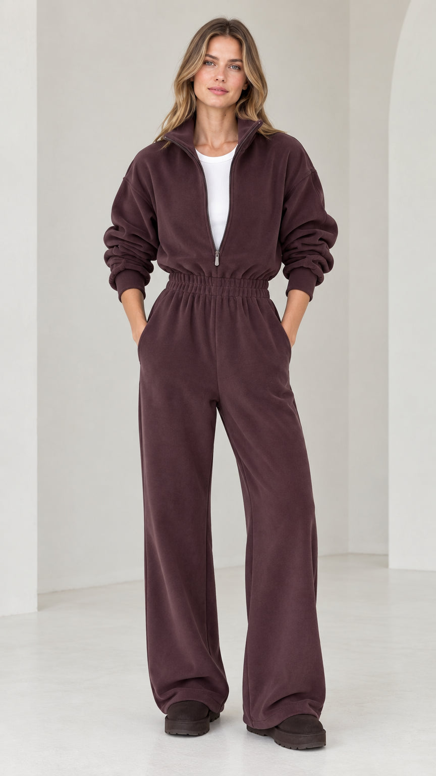 Front view of model wearing chocolate brown half-zip wide leg fleece jumpsuit
