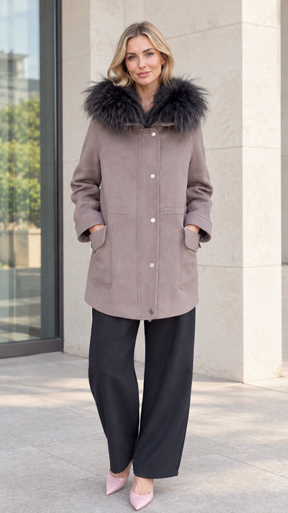 Front full-length view of model wearing taupe faux fur hooded parka coat with black wide-leg trousers