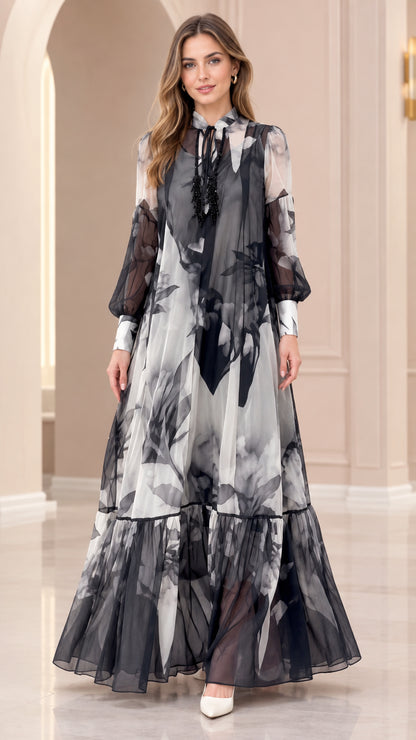 Front full-length view of black and white floral print chiffon tiered maxi dress