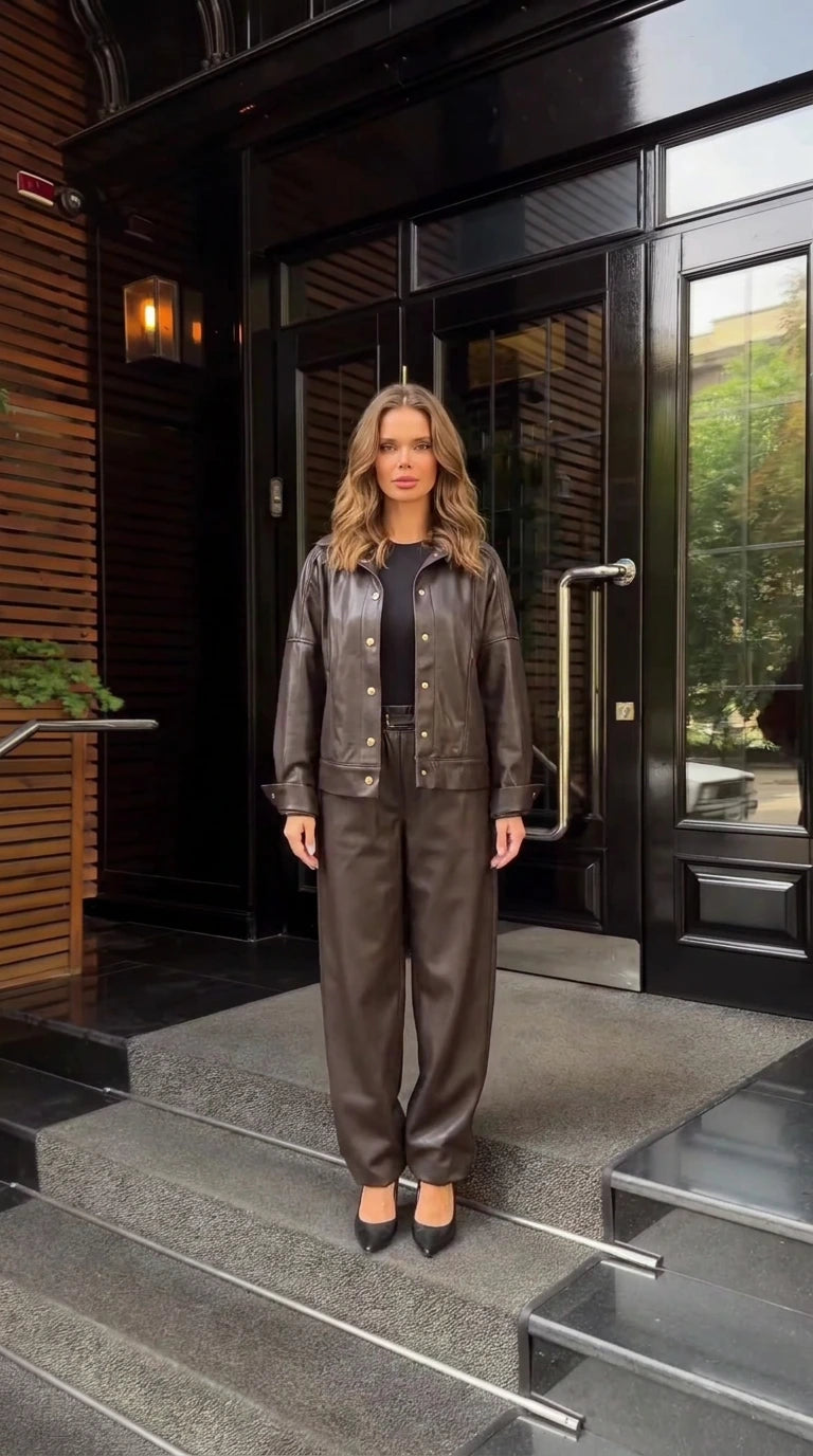 Front full view of woman wearing dark brown faux leather jacket and trousers set