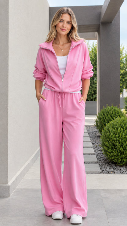 Full front view of model wearing pink zip-up jacket and wide leg pants tracksuit set