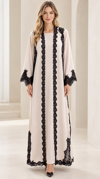 Front full-length view of cream modest maxi abaya dress with black lace trim