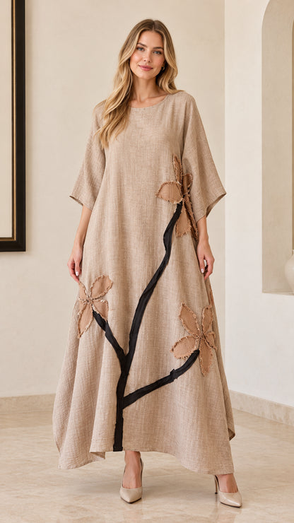 Front full view of woman wearing beige floral appliqué linen-look maxi dress