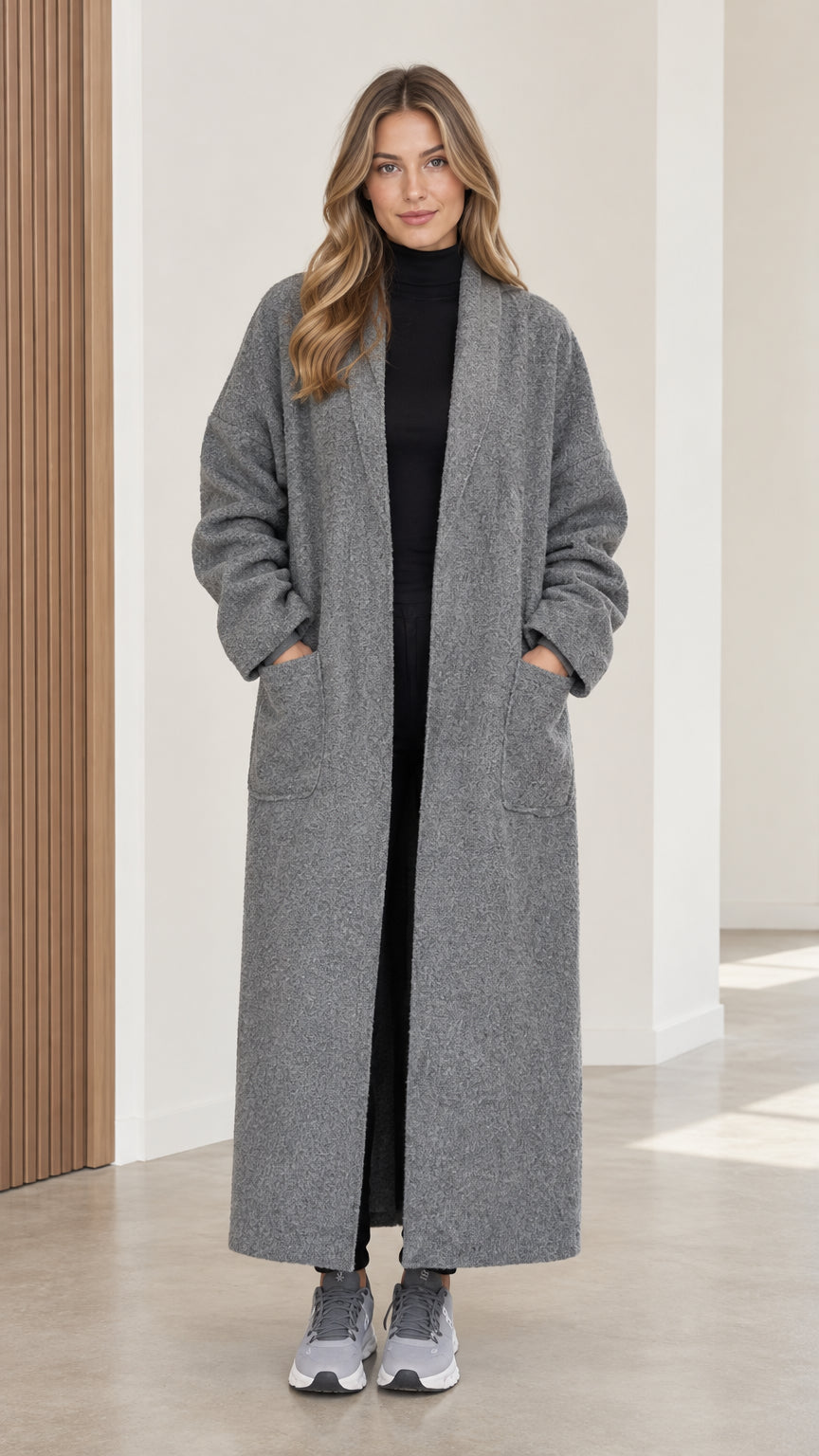 Full front view of women's grey bouclé maxi duster coat styled over black top