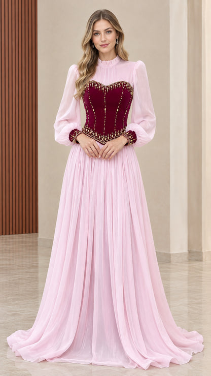 Front view of model wearing pink chiffon maxi dress with maroon velvet corset bodice