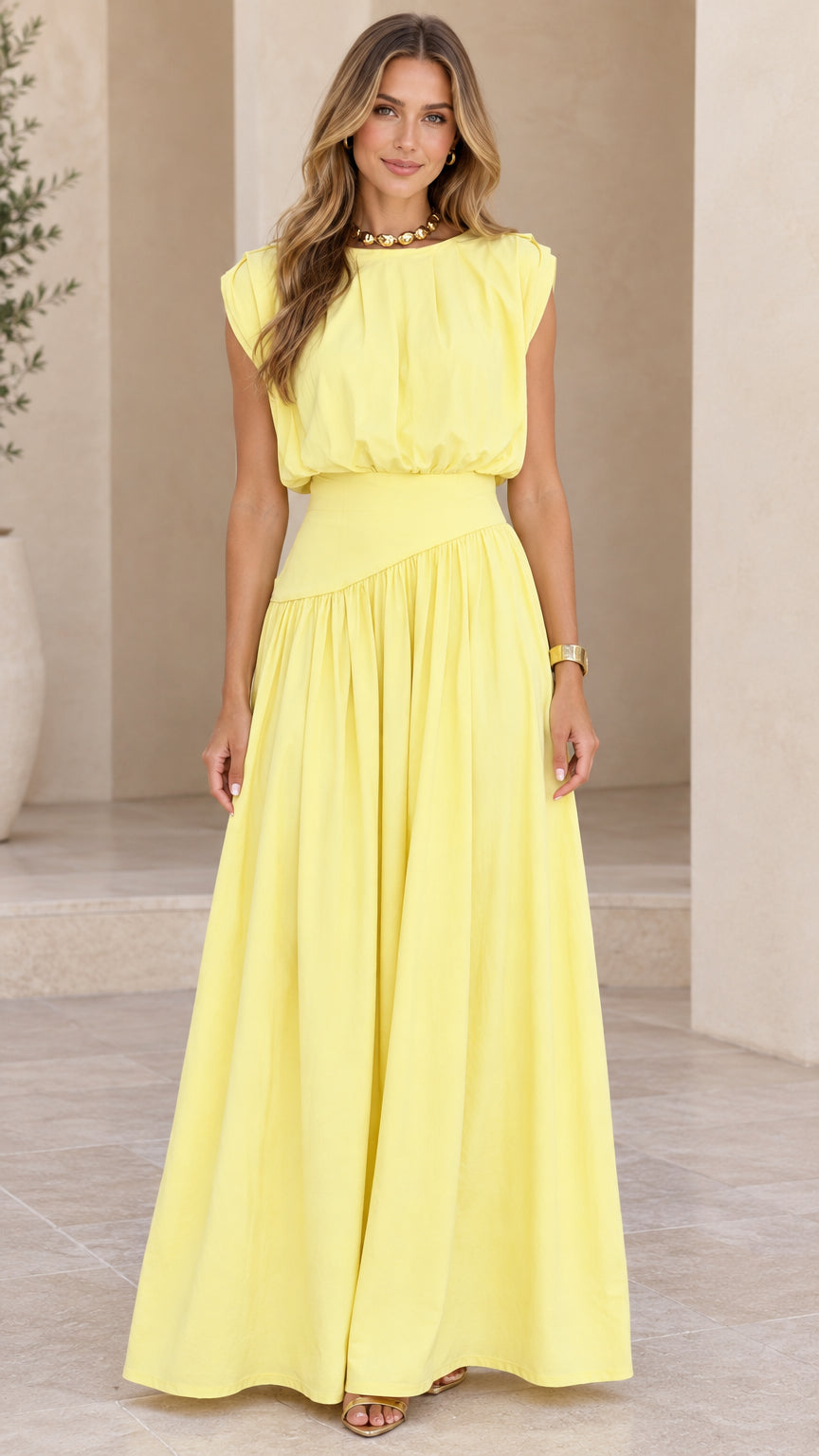 Front view of model wearing pastel yellow sleeveless pleated maxi dress
