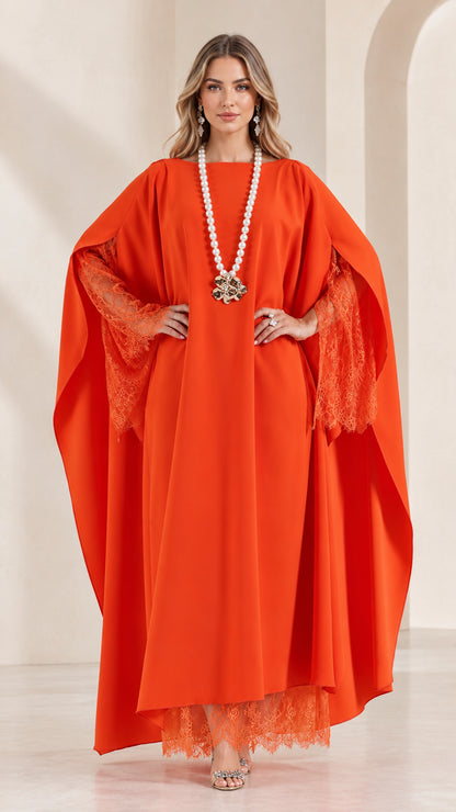 Front view of woman wearing orange cape sleeve kaftan maxi dress with lace trim