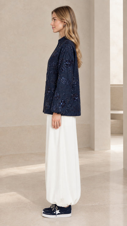 Side profile view of navy blue sequin embroidered long sleeve jacket blouse