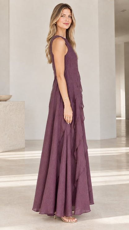 Side angle of woman in Plum sleeveless ruffled A-line maxi dress