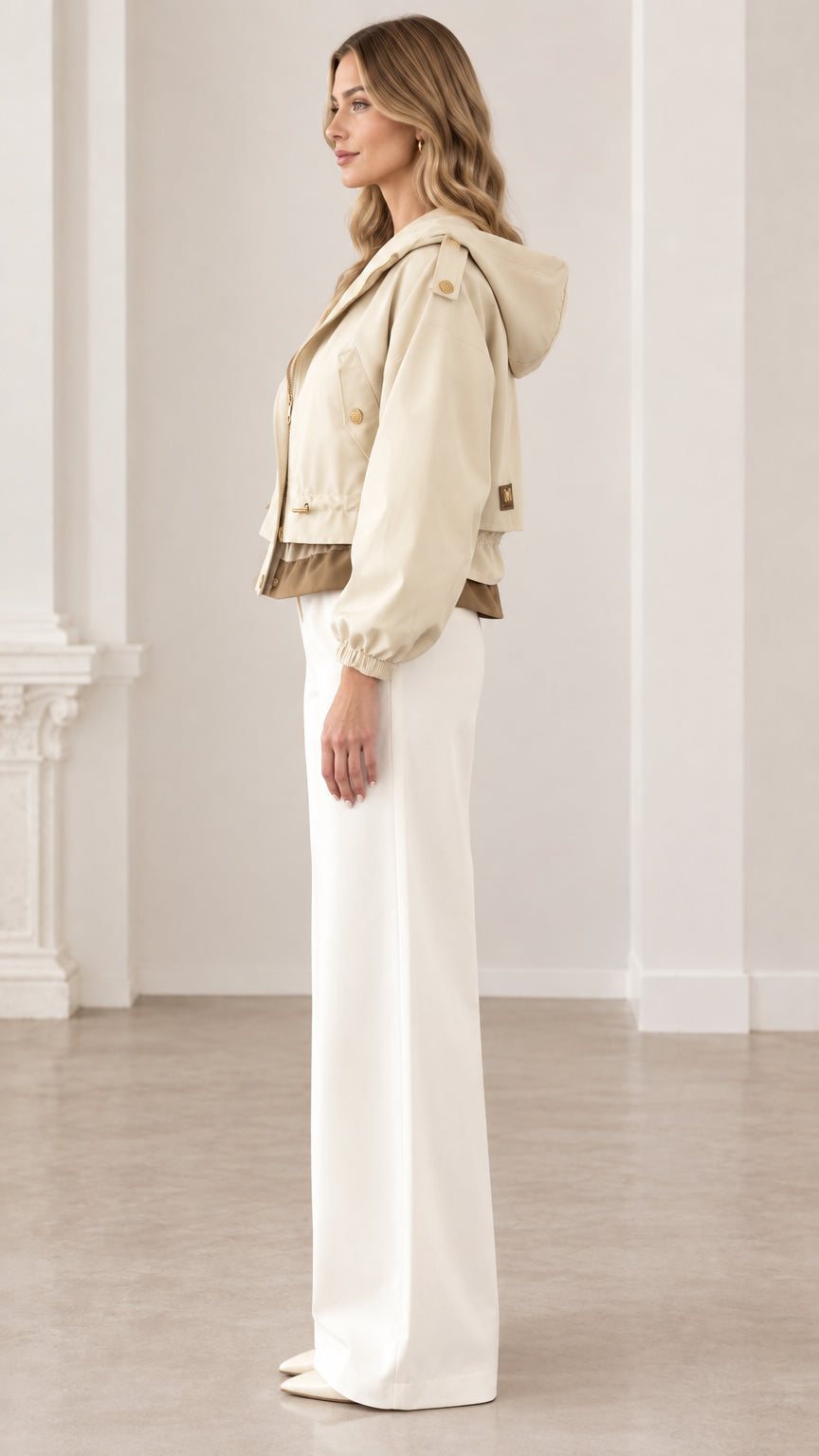 Side profile of woman wearing beige cropped hooded utility jacket