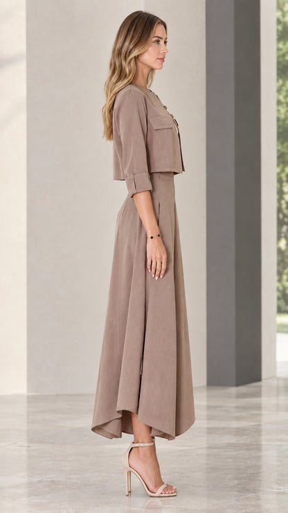 Side profile of model wearing taupe two-piece jacket and wide-leg trousers