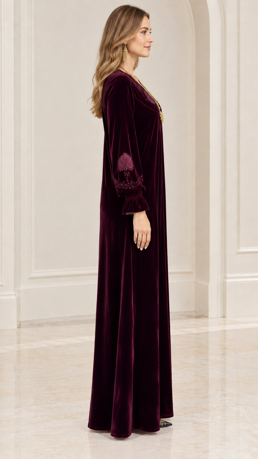 Side profile view of burgundy velvet long-sleeve maxi dress