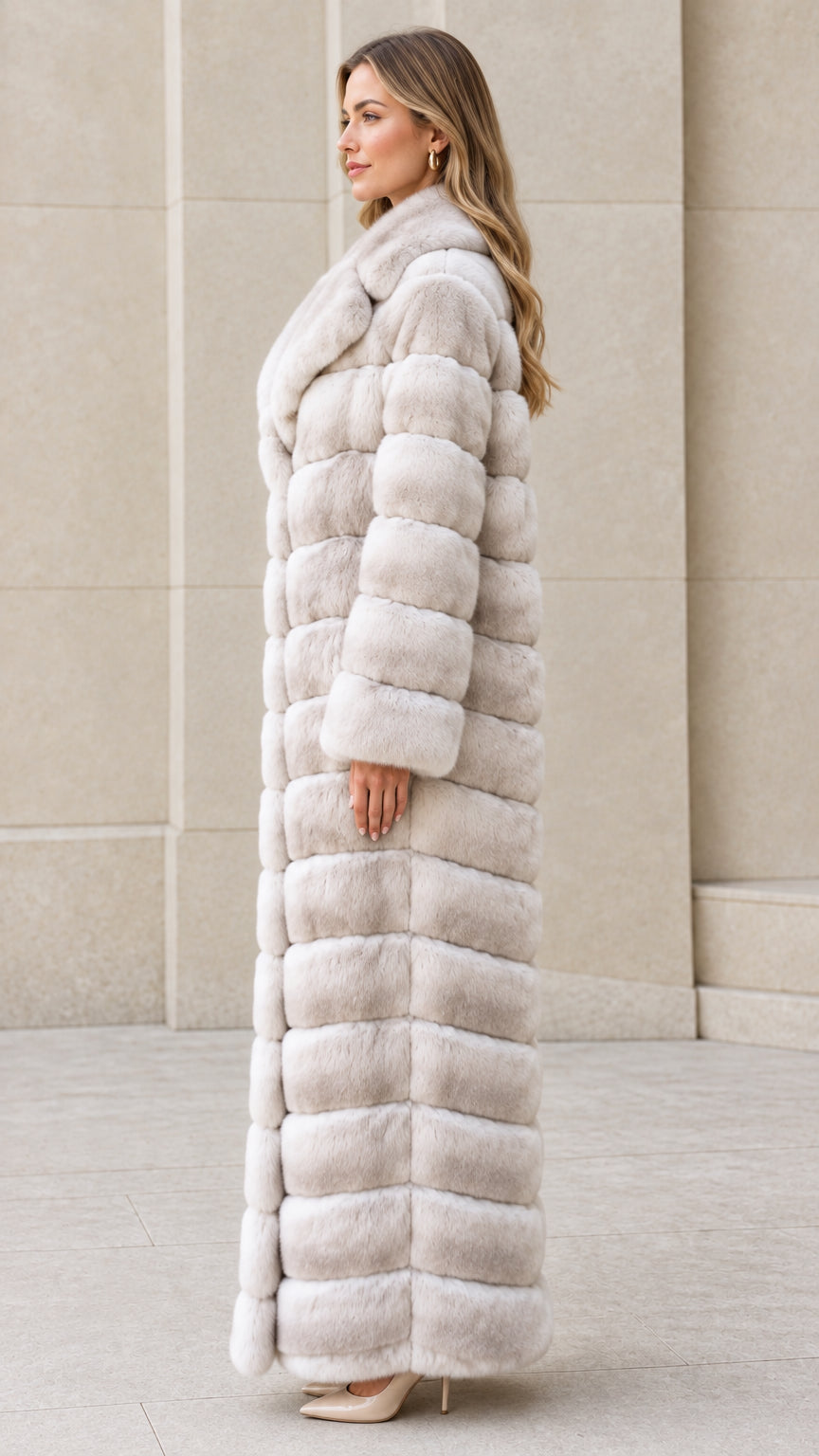 Side profile view of model wearing Light Gray full-length faux fur coat