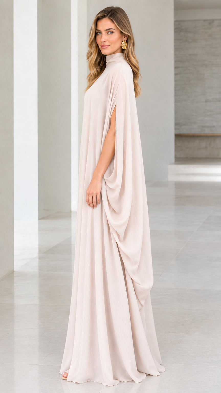Side profile view showing draped silhouette of champagne cape maxi dress