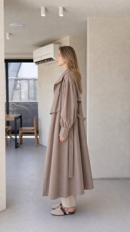 Side profile of model wearing the taupe brown longline maxi trench coat