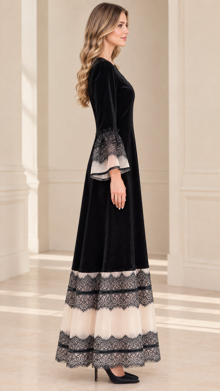 Side profile view of black velvet A-line formal maxi dress with lace cuffs