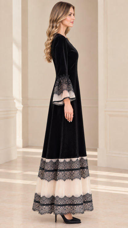Side profile view of black velvet A-line formal maxi dress with lace cuffs