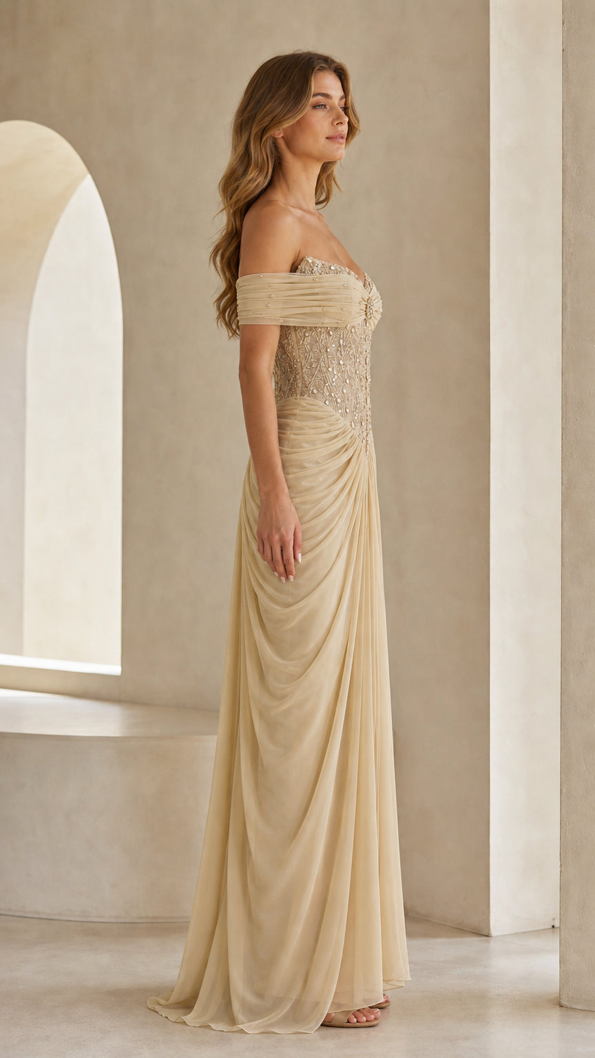 Side profile view of champagne draped formal maxi gown
