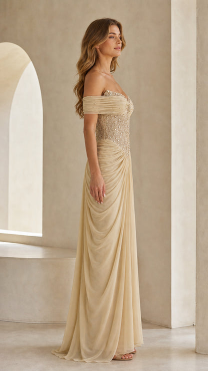 Side profile view of champagne draped formal maxi gown