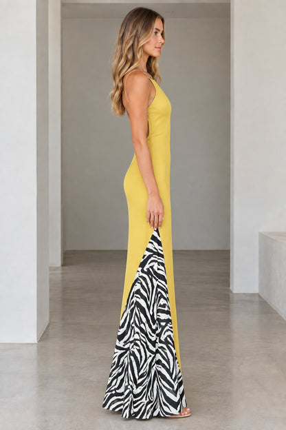 Side profile view of yellow spaghetti strap maxi dress highlighting zebra pattern insert