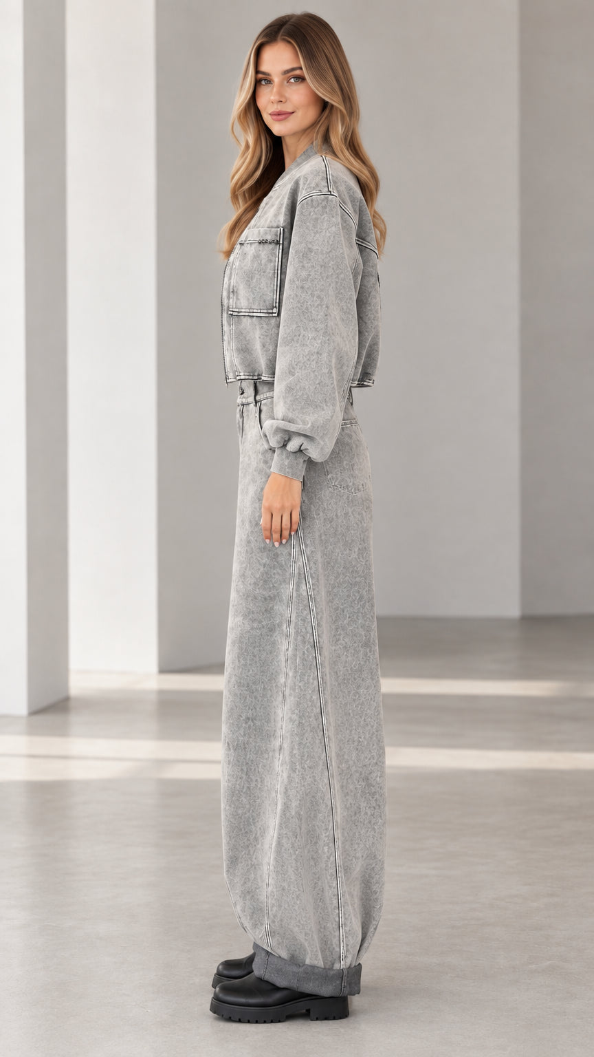 Side profile view of grey acid wash denim two-piece jacket and jeans set