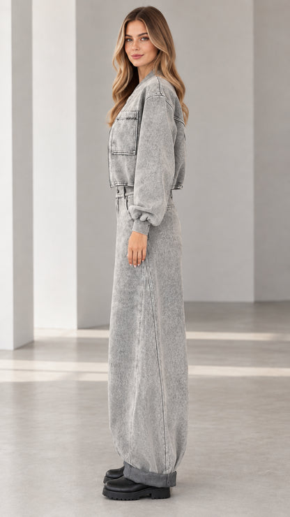 Side profile view of grey acid wash denim two-piece jacket and jeans set