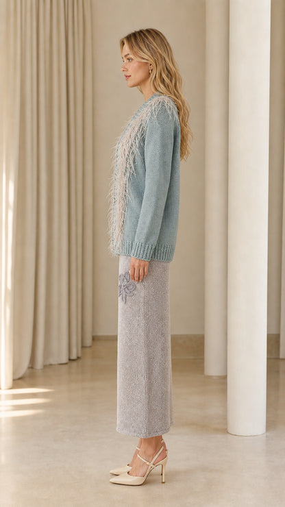 Side profile view of dusty blue feather trim cardigan sweater