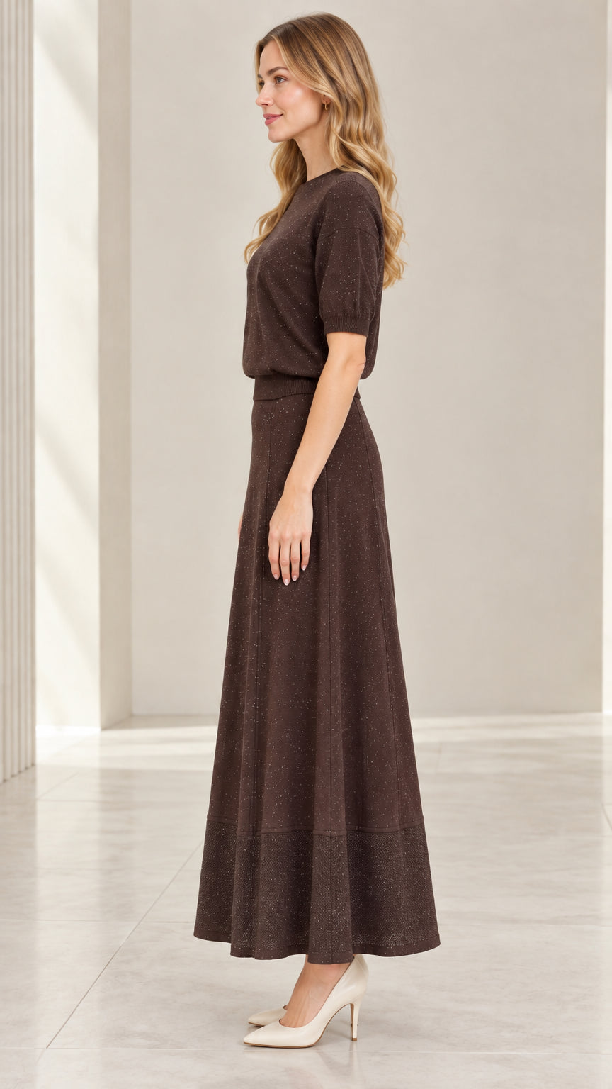 Side profile view of model wearing coffee brown two-piece sparkle knit skirt set