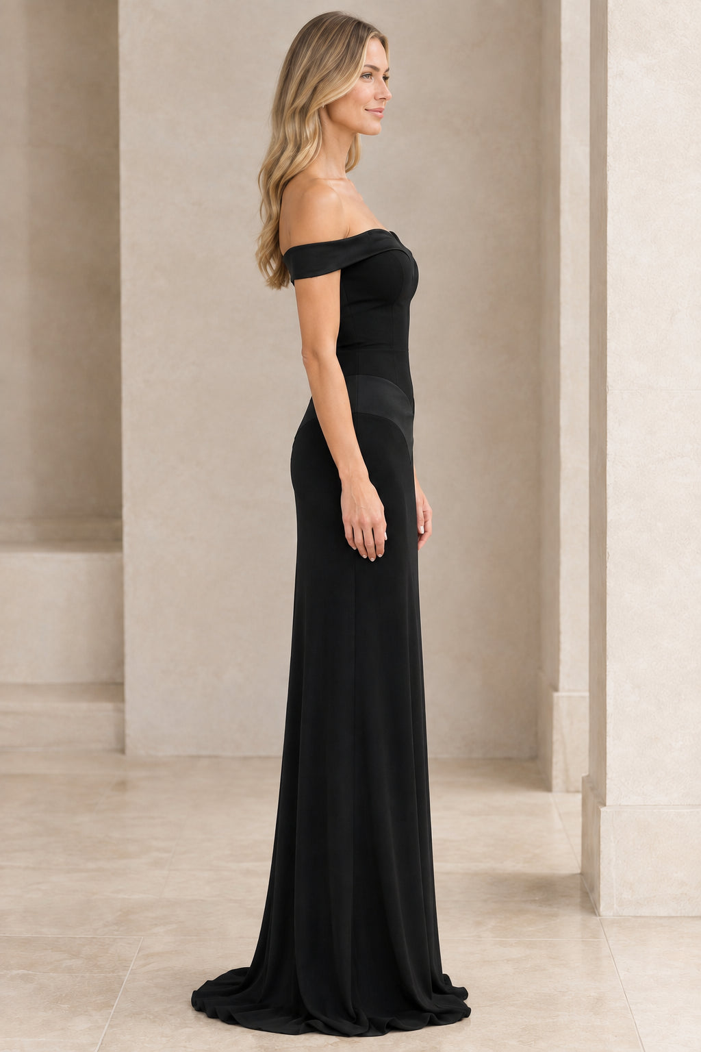 Side profile of woman in sleek black floor-length formal gown