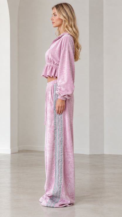 Side profile view of model in lilac pink velour lounge set showing cropped jacket and side stripe pants