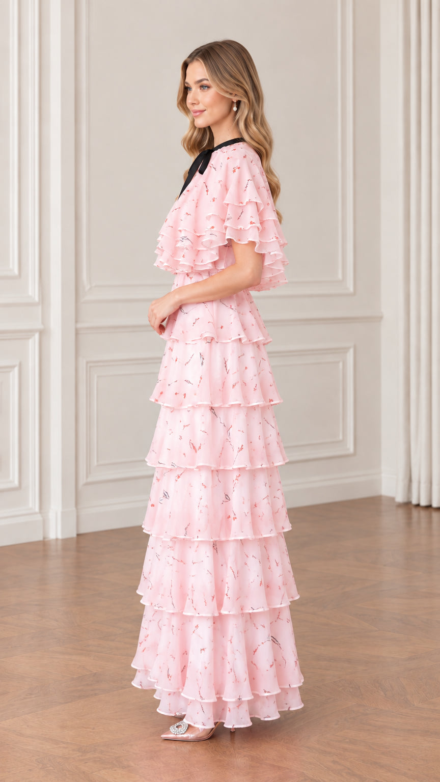 Side view of woman wearing pink floral tiered chiffon maxi dress