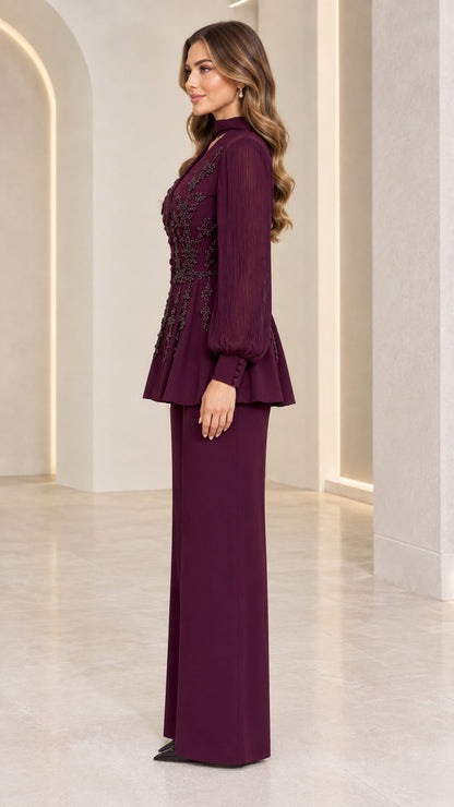 Side profile view of burgundy beaded peplum suit showing fit and sleeve drape