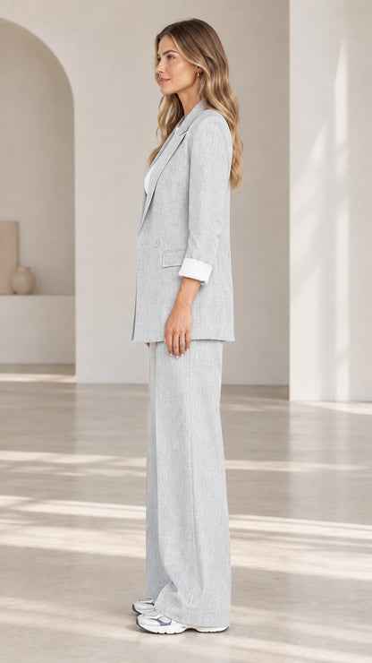 Side profile view of woman wearing Light Grey tailored blazer and wide-leg trousers set