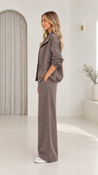 Side profile view of model in taupe casual two-piece pant set