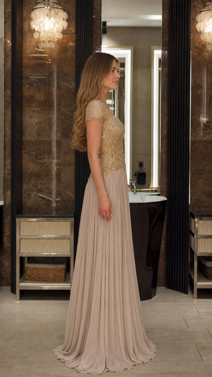 Side profile view of the Champagne beaded floor length formal evening gown