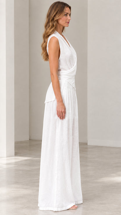Side profile view of woman wearing white sleeveless wide-leg jumpsuit