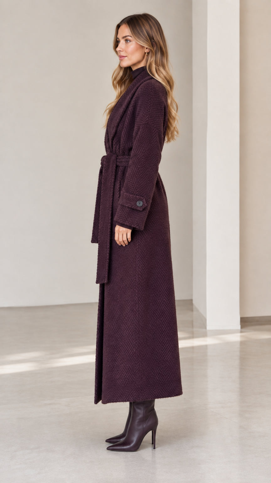 Side profile of woman wearing deep plum full length wrap coat