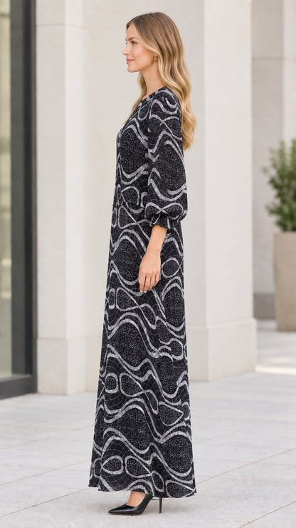 Side profile of model wearing black geometric wave print maxi dress